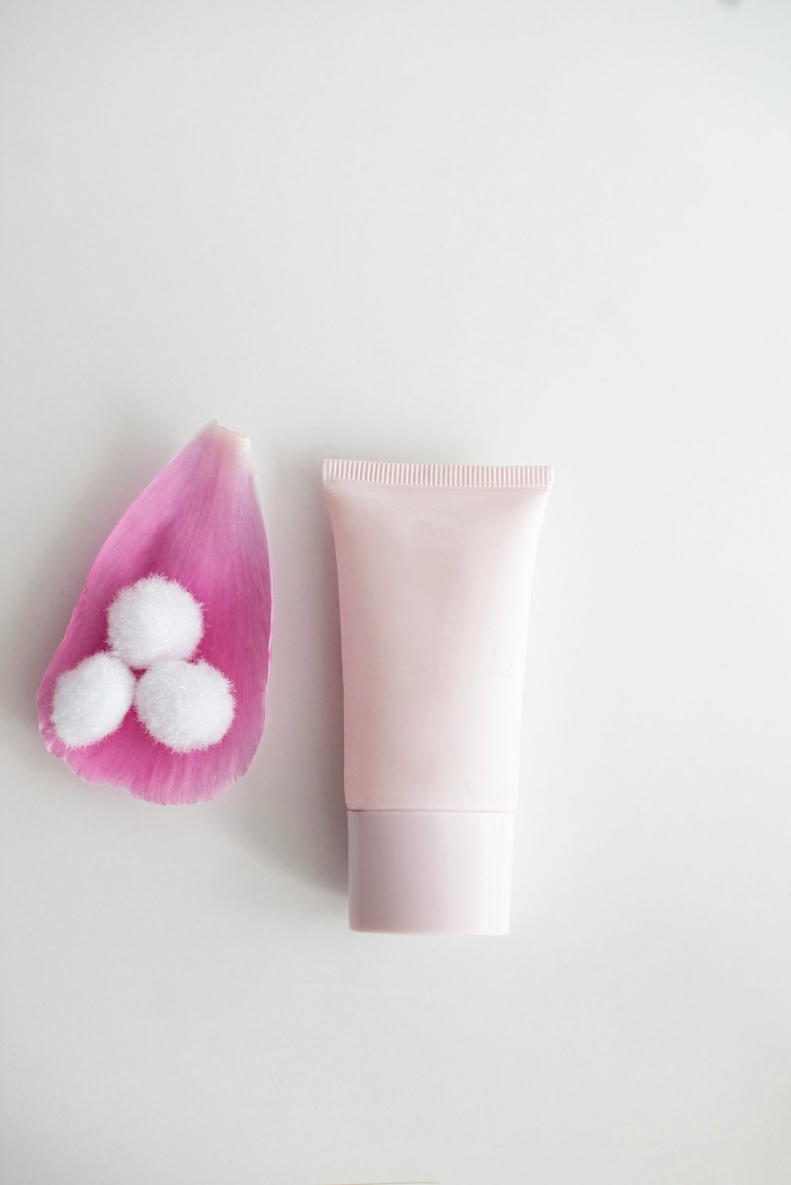 pink and white plastic tube bottle